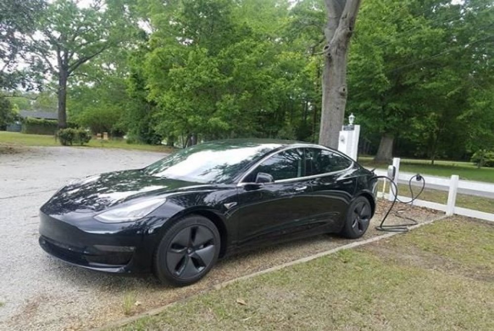 Tesla brand car charging outside