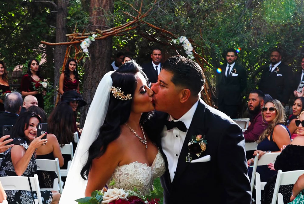 Wedding guests celebrating around bride and groom marriage ceremony