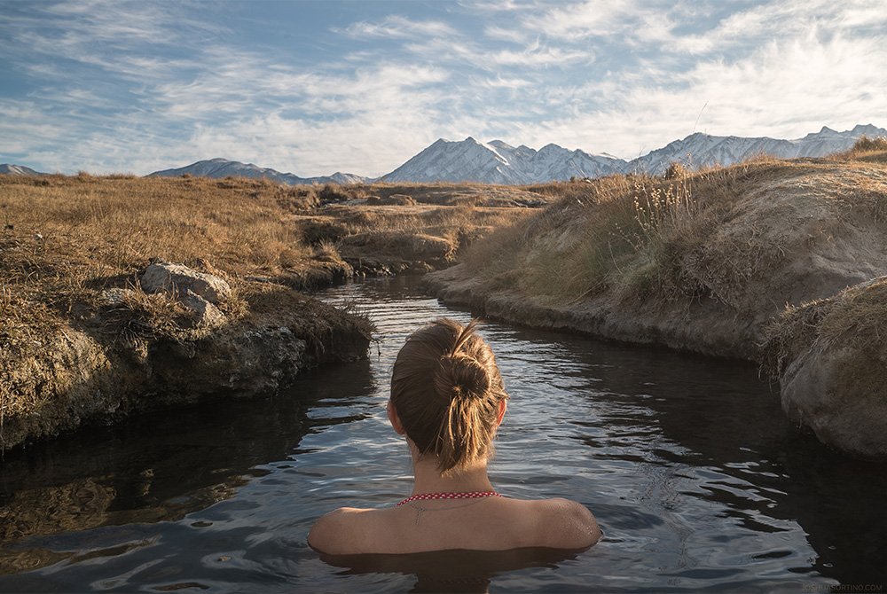 woman sitting in hot spring