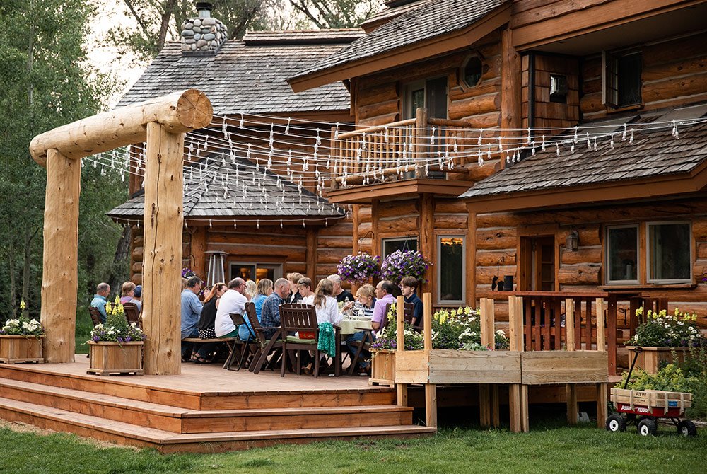 Large gathing of people eating on the patio