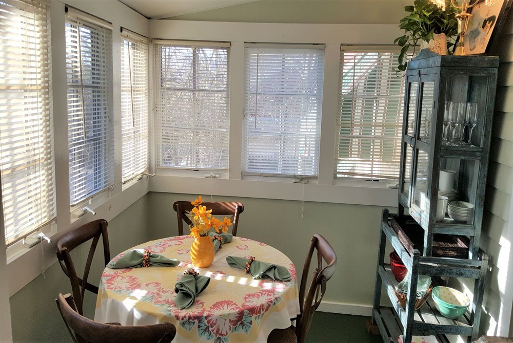 Dining room with table and small countertop next to bedroom and kitchen