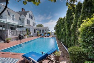 view of pool and various plants