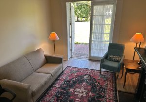 Living room with door leading to patio