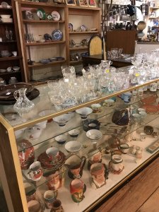 glass bowls and blue dishes in display case