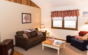 Sitting area with couch and armchair around coffee table