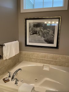 Wood chair and desk below mirror