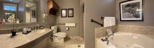 Wood vanity next to King-sized bed