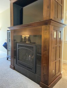 Fireplace, television, and vanity next to king-sized bed