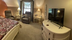 Bed and reclining chair under semi-vaulted ceiling