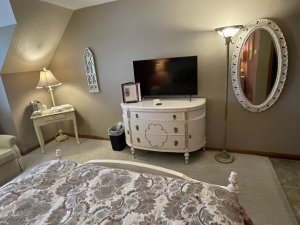 Wardrobe with mirror on door in corner