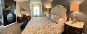 King-sized bed next to endtable with lamp