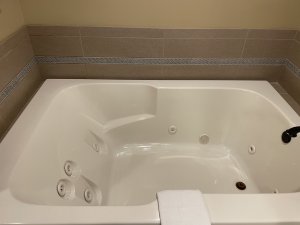 Doorway to bathroom with bathtub and sink
