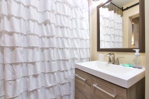 Tile shower with wood gated cabinet 