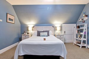 Pillows against headboard of bed next to bedside table