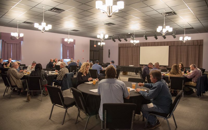 People sitting around tables at an event