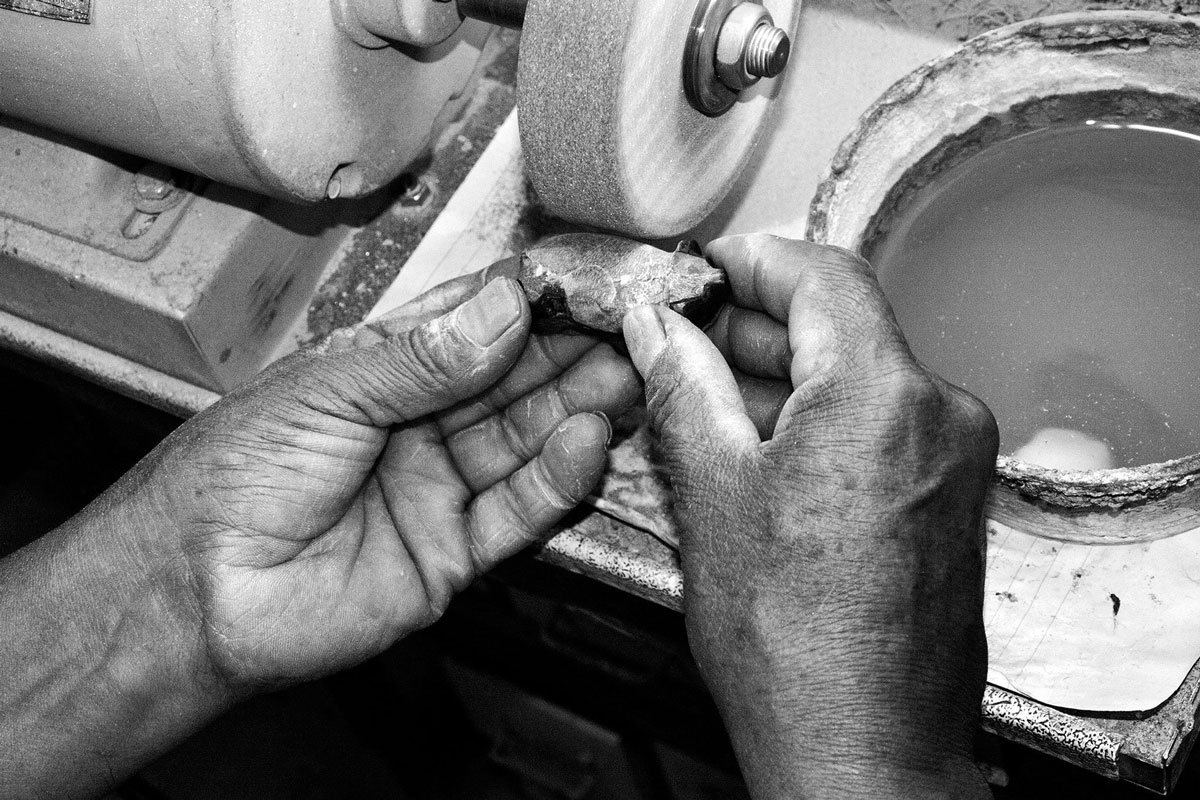 artisan's hands at the grinder