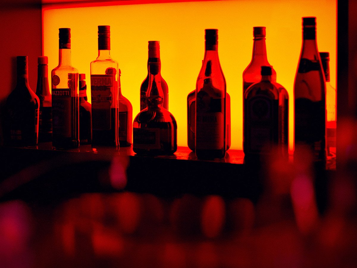 liquor bottles against a lit backdrop