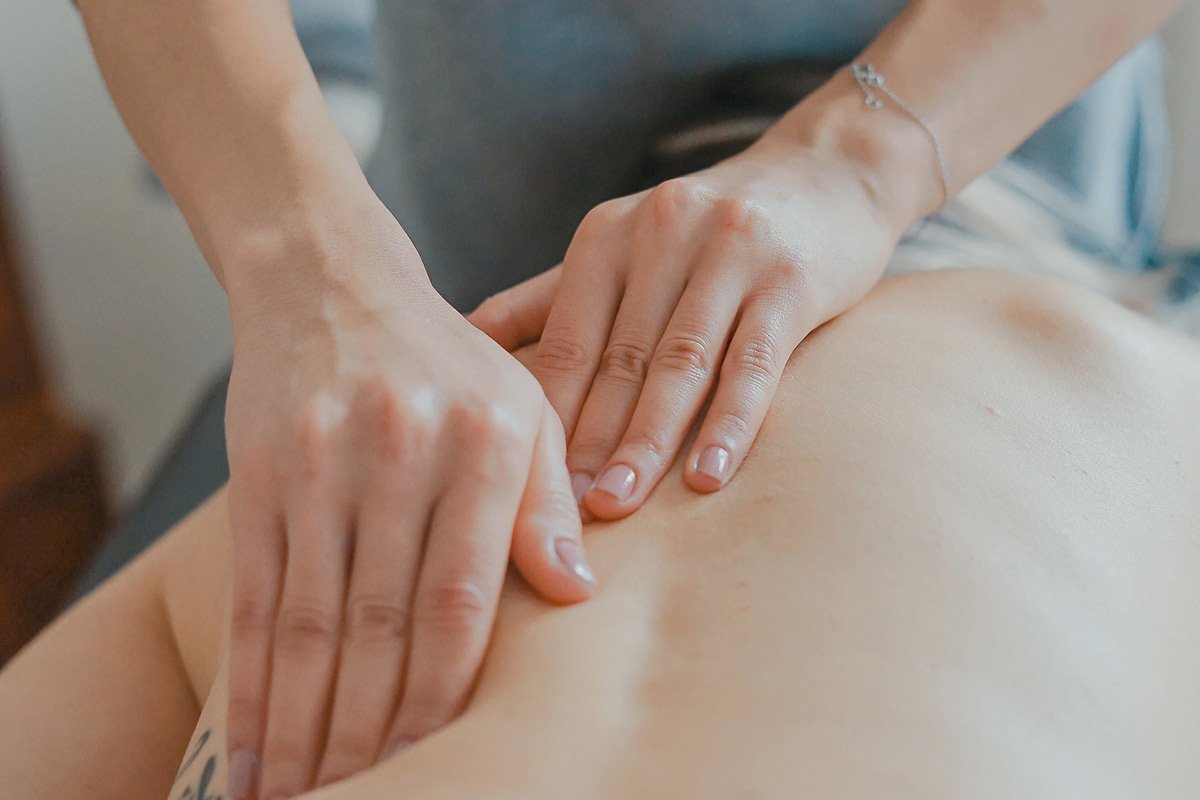 hands massaging a bare back