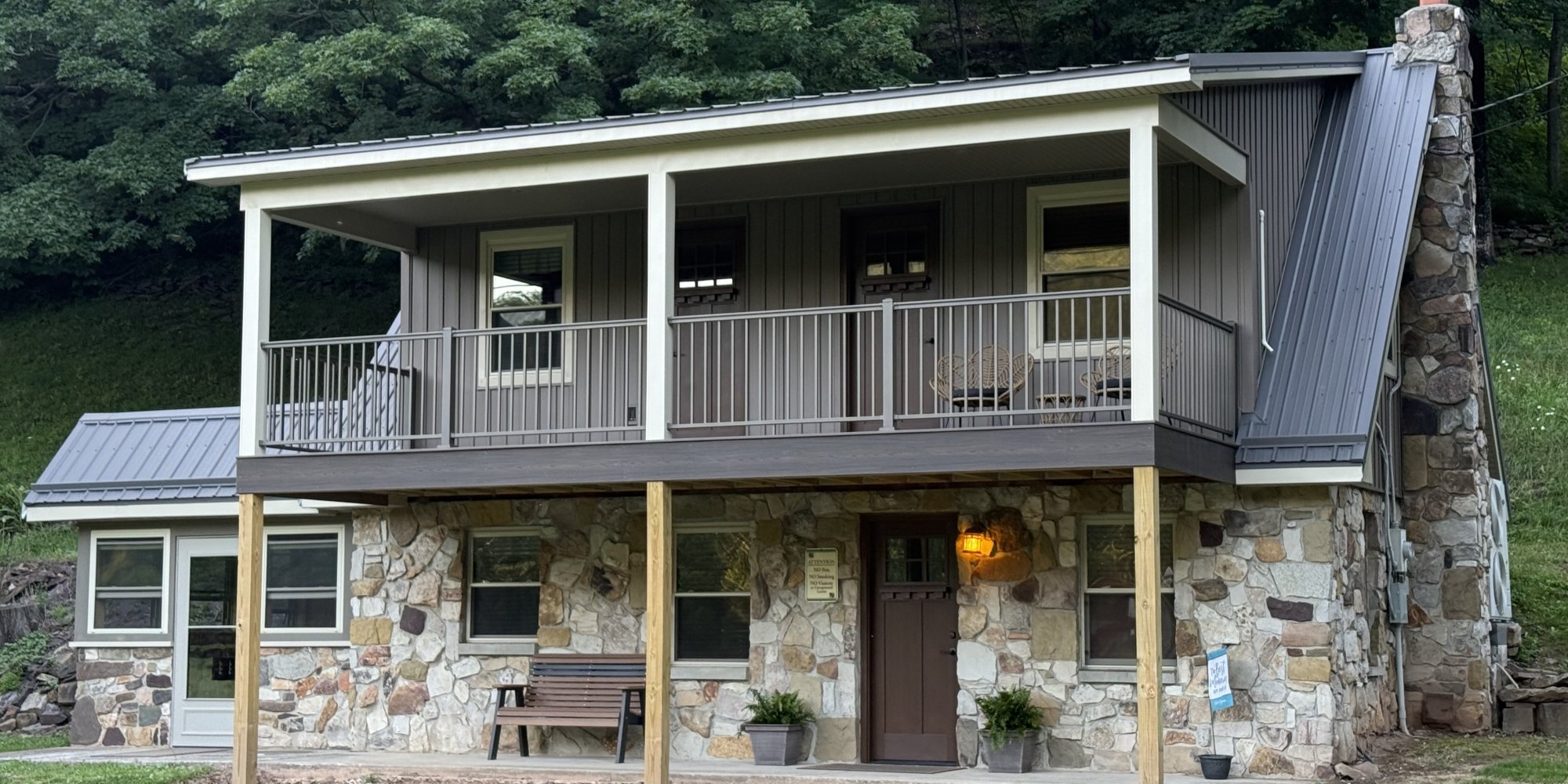 Two story house with stonework and upper deck