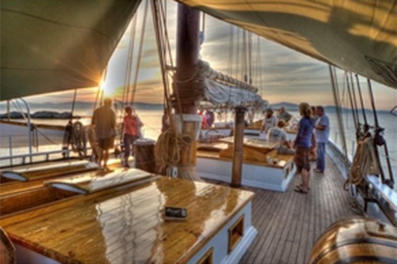 People standing on boat with tarp