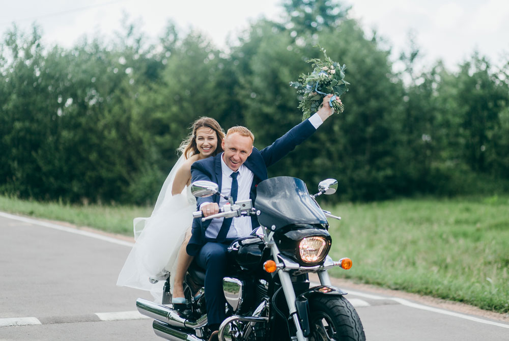 Bride and groom on a motorcycle