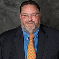 Bearded man in suit and tie