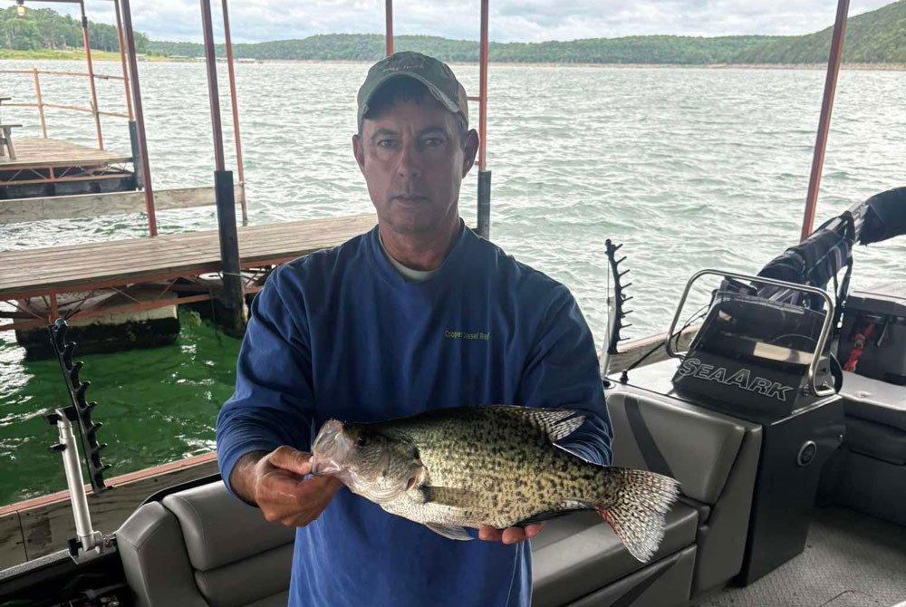 One man holding a large fresh-water fish