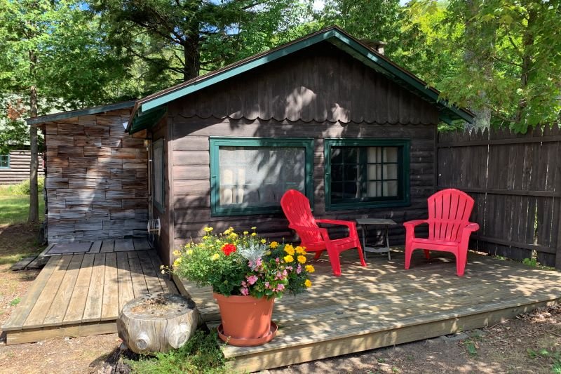 cabin with two porches and three chairs