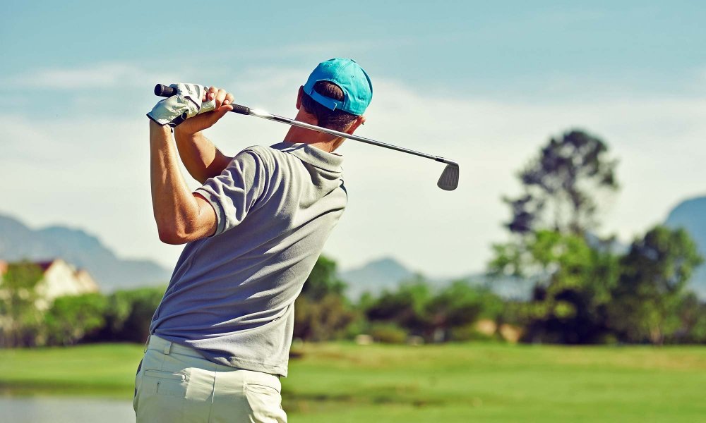 man swinging at golf